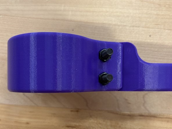 Screw the 2 M5 nuts on the other end of the bolts, this should be on the side with the hexagonal holes