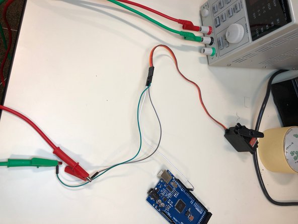 Attach a jumper wire(the thinner one with two pointed ends) from digital pin 9 to the orange colored female pin from the servo. Then, attach a male to male j. wire from the red wiring of the servo to the alligator clip from the positive end of the bench power supply and a male to male j. wire from the brown wire on the servo to the negative end.