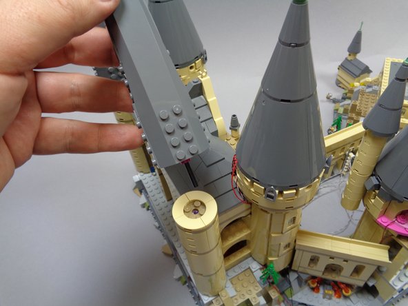 As shown in the photos for this step, replace the two rear towers you removed when you began working on the second half of the castle.