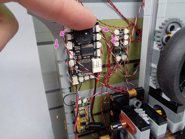 As shown by the purple arrows in the photo for this step, you can adjust the volume of sounds played by turning the black dial on the main effect controller (one direction for louder volume, the opposite direction for softer volume).