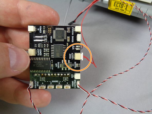 As shown in the first photo for this step, connect the red control wire from the roof to the plug labeled &quot;ROOF LIGHTS&quot; on the main controller.