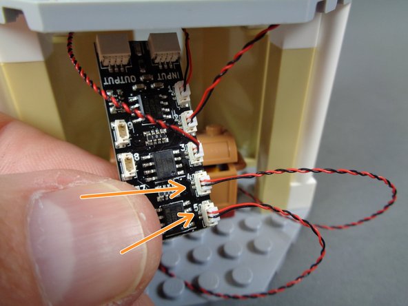As shown by the two orange arrows in the third photo, connect the two LED light wires to plugs #4 and #5 on the BRANCH09X adapter board.