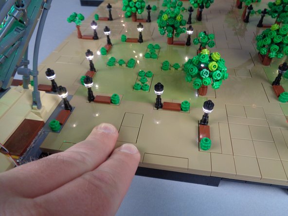 Once all wires have been collected underneath the panel, carefully re-attach it as shown in the second photo for this step, pressing firmly to re-attach the panel.