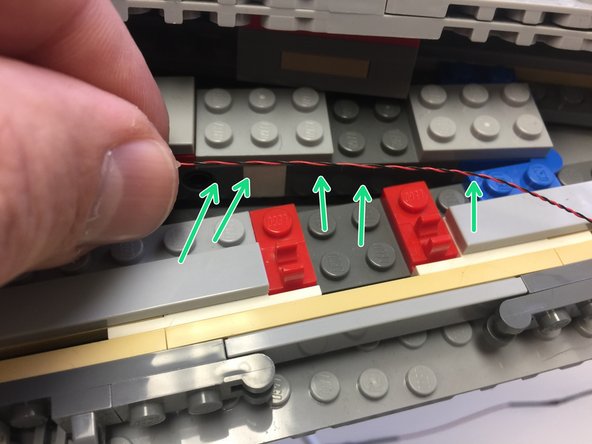 Make sure all wires run behind, not on top of, hinge clips as shown by the green arrows in the second photo.