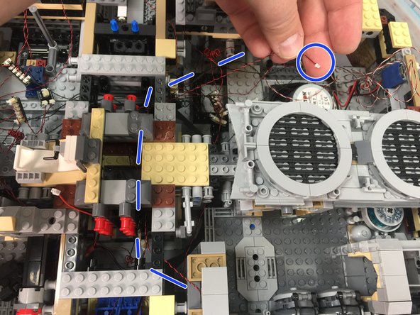 As shown by the red circle in the second photo, re-attach the door frame top so the LED light is at the back of the frame and the light wire extends out the back of the frame.