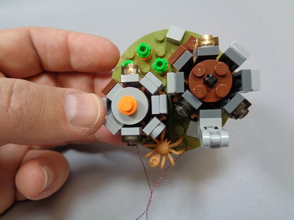 As shown in the second photo, you should now have all side pieces re-positioned with both lights in the front section and two wires coming out the back of the huts.