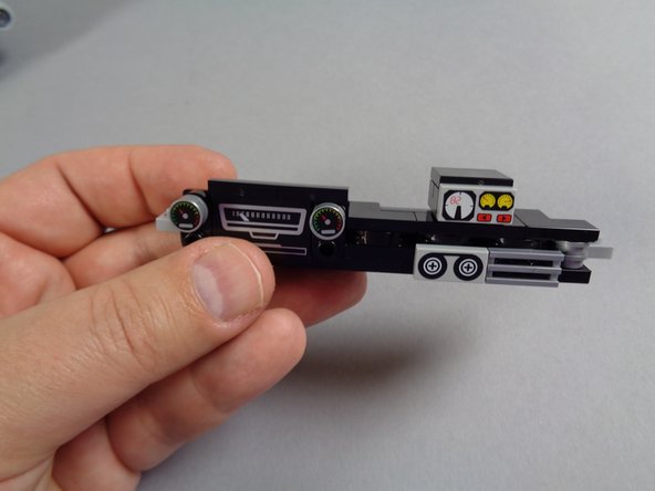 As shown in the second photo for this step, remove the large light bluish gray plate with the dashboard attached to it.