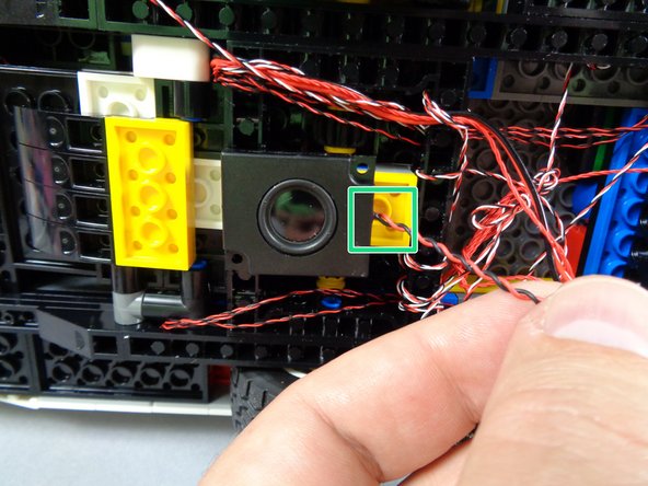 As shown in the first photo for this step, it is recommended to attach the small speaker to the rear center of the Ecto-1, on top of the rear axle assembly.