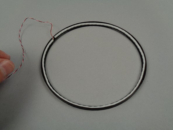 Your light strip has a self-adhesive backing, covered by a brown strip.  You don't need to remove the strip or use the adhesive to mount the light strip inside the frame.  By not using the adhesive, you can make it easier to switch to the crescent moon frame later.