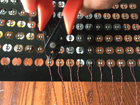 After you have soldered both wires and gently tugged each to make sure both wires are firmly attached, use clippers to cut the top &quot;finger&quot; above each LED board.