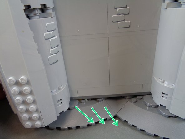 As shown by the green arrows in the third photo, carefully slide the castle wall out a small amount.  You will feel when it stops and cannot swing out any further.