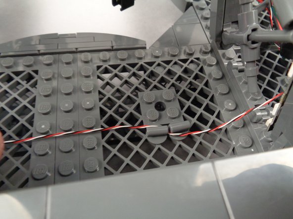 Insert two of the pieces into the large grid plates where you want to secure wires.  To make it easier to insert wires, you can turn one of the parts sideways.