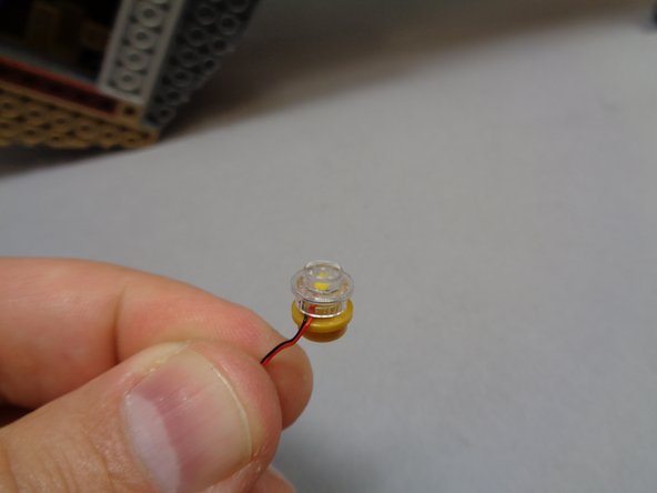 Re-attach the transparent top of the lamp as shown in the third photo.