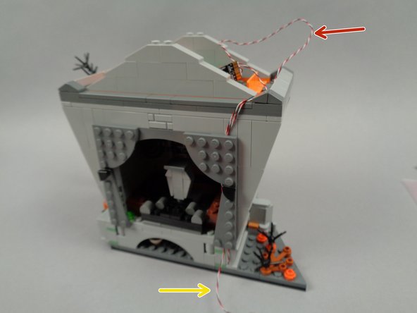 The excess wire for the fountain light strip should be gathered in the attic as shown by the red arrow in the second photo.