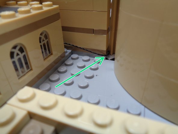 As shown by the green arrow in the first photo, feed the light strip wire along the rear courtyard wall and through the gap between the tower and the main castle.