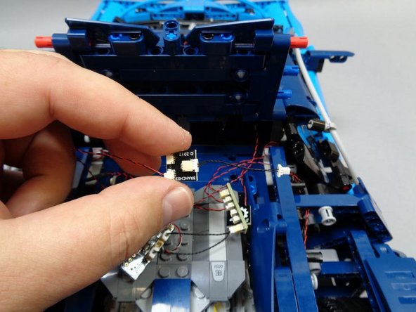 Now would be a good time to double-check that you have all lights connected to the correct plugs on the main controller board.  Only one plug should still be open: the single plug at the bottom of the board (blue square, third photo).  This is where you will connect the power supply in a later step.