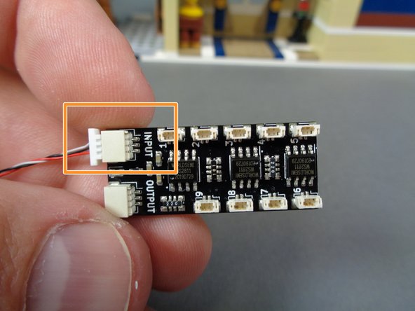 There are two special wires inside the bag, both with white plugs on one end and black plugs on the other end.  For this step, make sure you are using the wire that has the black plug with gold pins as shown by the yellow circle in the second photo (the &quot;male&quot; version of the plug).