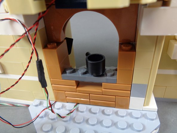 As shown in the photos for this step, continue re-assembling the stove.  By the end of this step, your stove should be completely re-assembled as shown in the third photo.