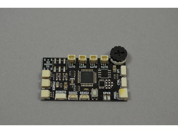 Remove the master controller board from Bag 1.  The controller, labeled TRUNK08 on the bottom side, is shown in the first photo.