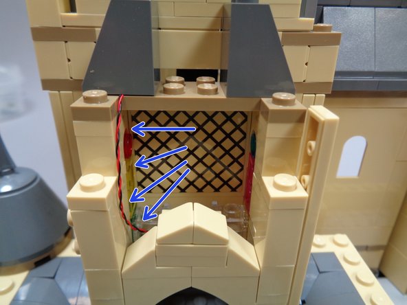 The blue arrows in the second photo show how the wire should run.