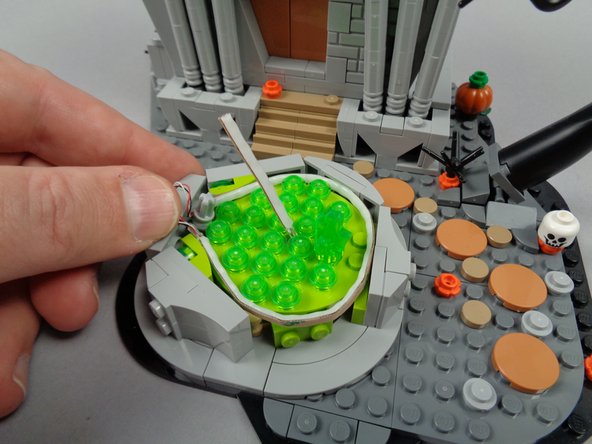 Continue routing the light strip around the rim of the fountain until it circles the fountain completely as shown.