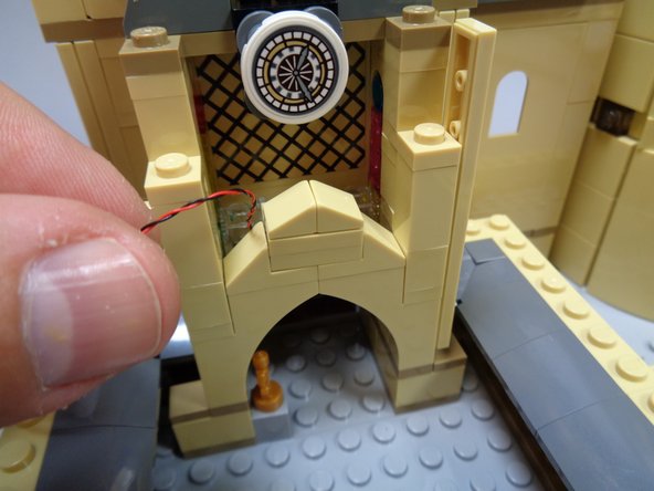 Carefully re-attach the arch top as shown in the photo.  The light should be facing the inside of the arch.