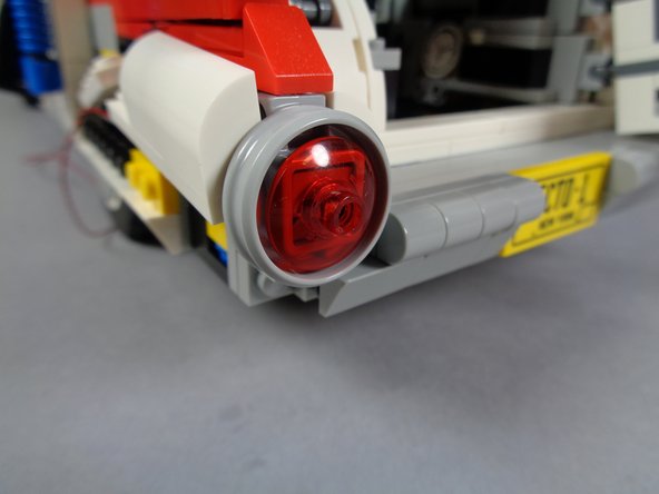 Remember to leave a little slack and pinch the wire along the side of the stud on the plate under the LED light-- this will help the transparent red dish remain attached to the tail light frame.