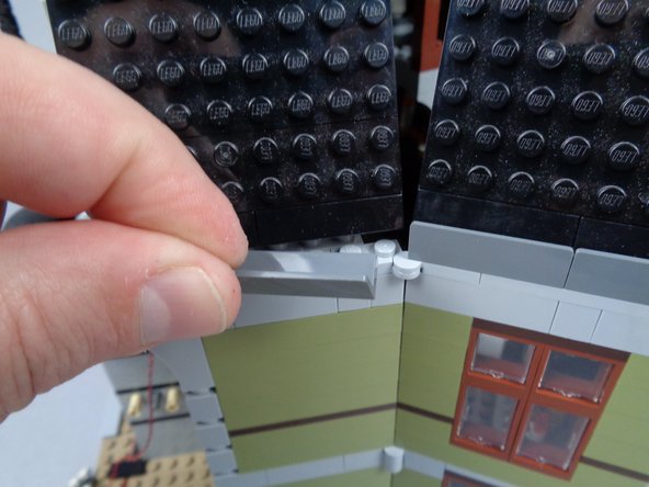 As shown by the photos for this step, remove two parts from the rear side wall: