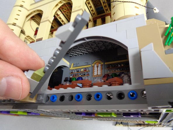 As shown in the first photo, remove the long dark bluish gray plate just below the front of the Potions Class.