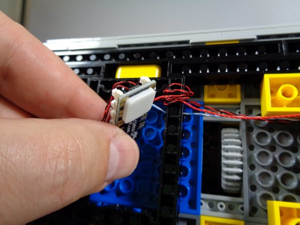 To keep things tidy, you can use a large sticky square attached to the back of the BRANCH09X adapter to attach the adapter to the bottom of the Ecto-1 as shown in the second photo.