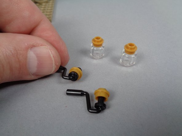 As shown in the third photo for this step, remove the clear and top gold parts from both porch lights.