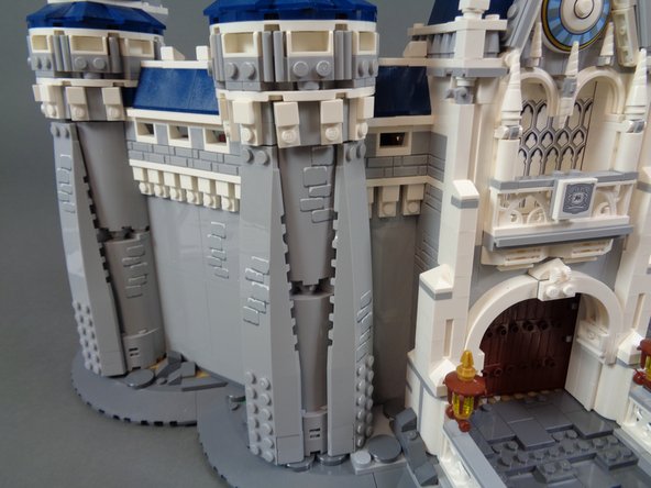 As shown in the second and third photos, re-attach the long slope to the outside of the castle tower.