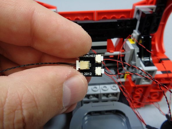 As shown in the second photo, connect the two headlight assemblies to the small connectors on the BRANCH03 adapter board, and connect the included black 12&quot; cable to the large connector on the BRANCH03 board.