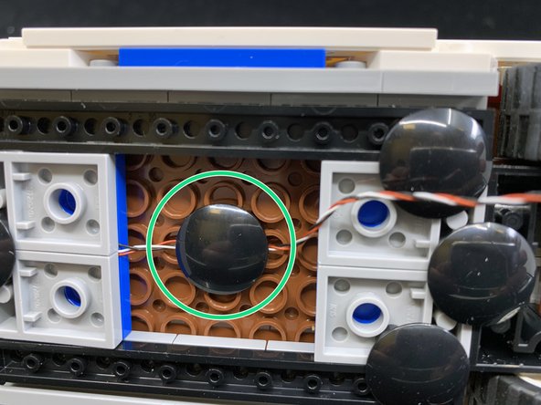 As shown by the green circle in the second photo, make sure the wire extends toward the back of the Ecto-1.  Secure the wire using the &quot;boat stud&quot; supplied with your Brickstuff kit.