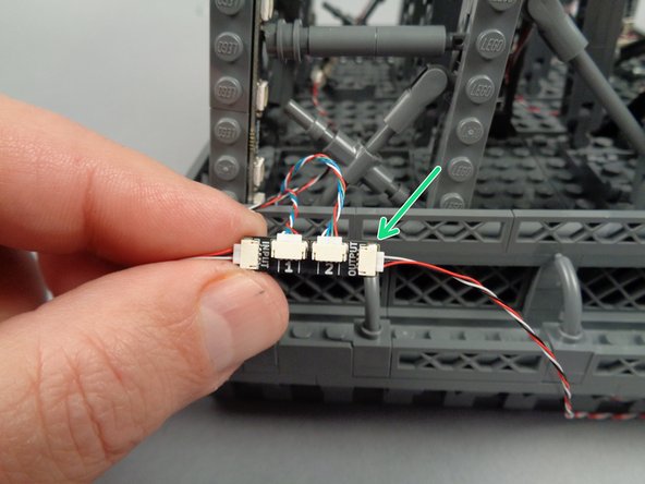 As shown by the green arrow in the photo for this step, connect the final 3-wire control cable to the OUTPUT plug on the adapter board.