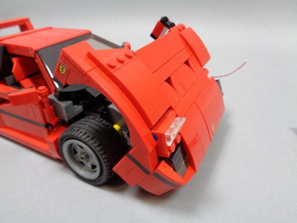 Carefully re-attach the plates you removed to run the wires.  The wires should now run into the center of the underside of the hood.