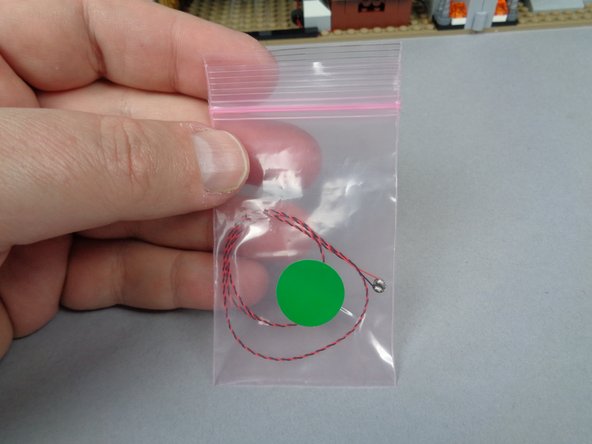As shown in the first photo for this step, remove the second green Pico LED light from the bag with the green sticker.