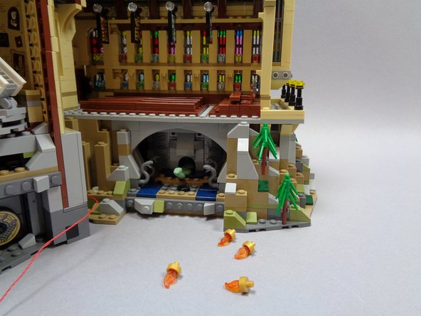 To prepare for installation of the four main hall torches, remove the torches that came with your LEGO® set as shown in the first photo.