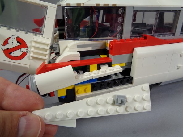 As shown in the second and third photos for this step, remove the other parts of the rear right lower frame.