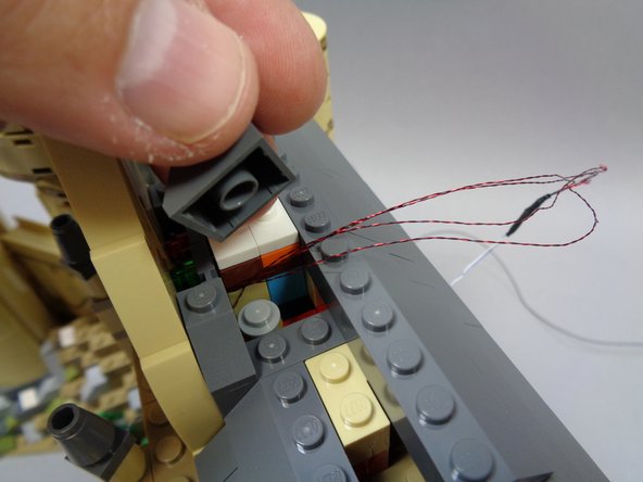 As shown in the first photo, remove the 2x2 corner roof slope part to make room for running the stained glass window wires.