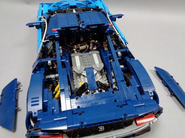 As shown in the first two photos, remove the two rear side panels and left/right beams if needed to allow the rear roof section to open up.