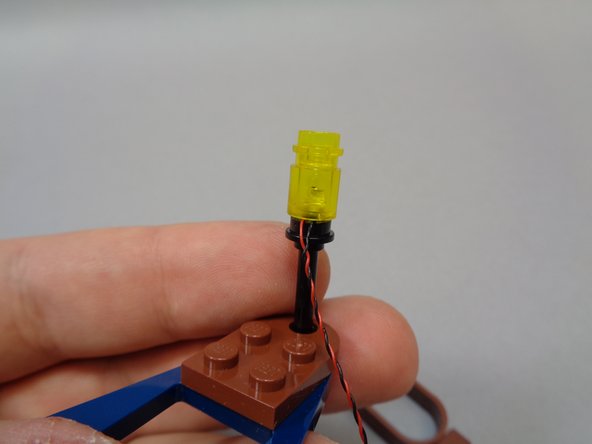 As shown in the first photo, re-attach the lantern assembly to the top of the black rod.