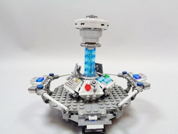 Gently press the top of the console onto the topmost transparent light blue core brick.  It should sit firmly on the top of the core, but note that unlike with the original model, the console top may detach if the model is bumped, because there is no longer an axle running through the center of the core.