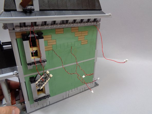 Carefully re-attach the rear bedroom wall, press down on the Haunted House frame to secure all bricks, and replace the light bluish gray pillar at the corner of the bedroom.