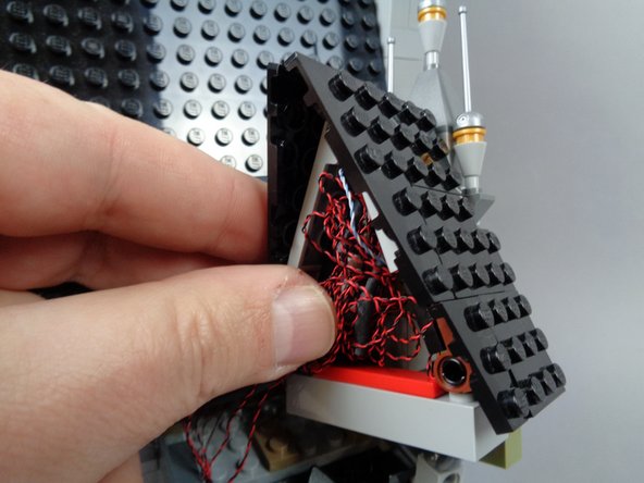 The first photo for this step shows the BRANCH12X adapter board placed on an angle in the space beneath the roof.