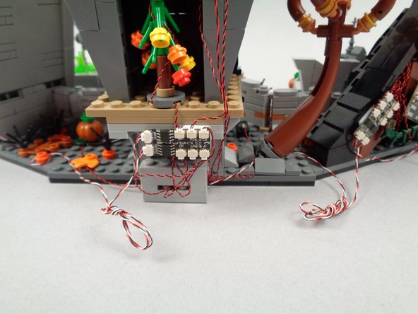Optionally, as shown in the photos for this step, you may also choose to coil up excess wire for the control wires that run between sections of your LEGO set.  This will make for a cleaner setup, but just make sure the wires can be easily accessed if they need to be connected/disconnected in the future (for transport or movement of your LEGO set).