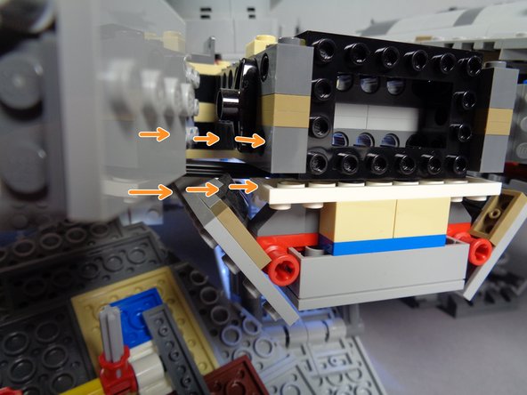 The orange arrows in the third photo show how the axle should pass into the boarding ramp area.