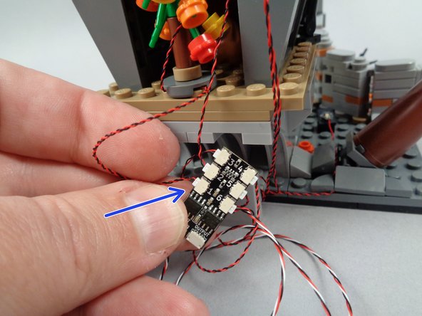 As shown by the arrow in the photo for this step, connect the Christmas tree light to the last open plug (#1) on the BRANCH06X driver board.