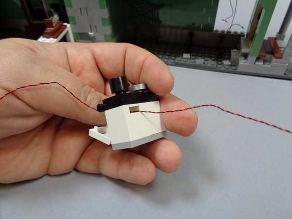 As shown in the second photo, feed the light through the back slot in the oven.