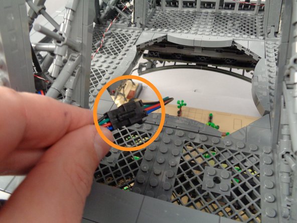 As shown in the first photo for this step, place your tower's middle section on top of the base section with the "A" pillars of both sections aligned.  The green lines in the photo show the locations of the first pair of light strips for both levels-- these should be aligned.